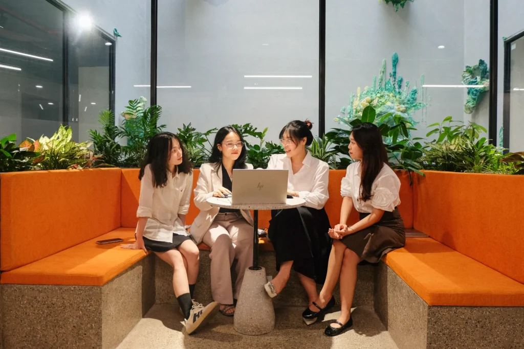 Team collaboration at Toong coworking space with casual seating and laptop discussion.